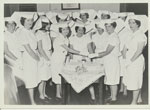 Rockhampton Hospital nursing graduates cut their graduation cake Dec 1965.